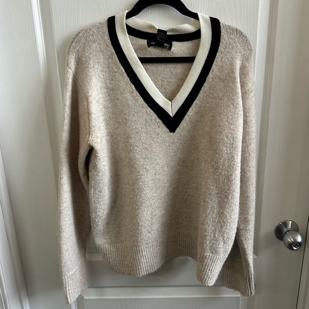 Elegant Beige V-Neck Sweater with Black and White Trim